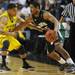 Michigan freshman Trey Burke looks to knock the ball loose from Ohio University sophomore Nick Kellogg in the second half of the second round of the NCAA tournament at Bridgestone Arena in Nashville, Tenn.  Melanie Maxwell I AnnArbor.com